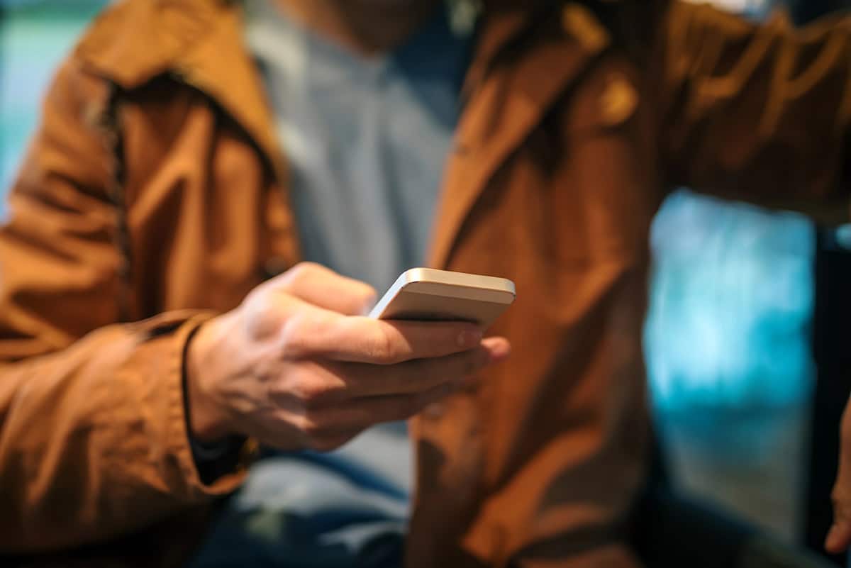 man using cell phone in hands